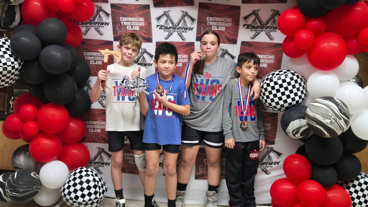 Texans wrestlers with medals from a tournament in Oklahoma