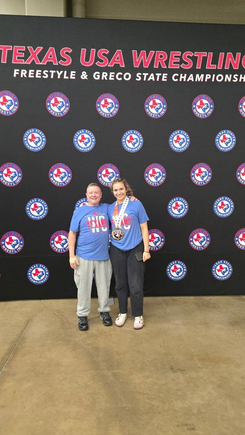A Texans wrestler with her medal at the Texas USA Wrestling Freestyle and Greco State Championships