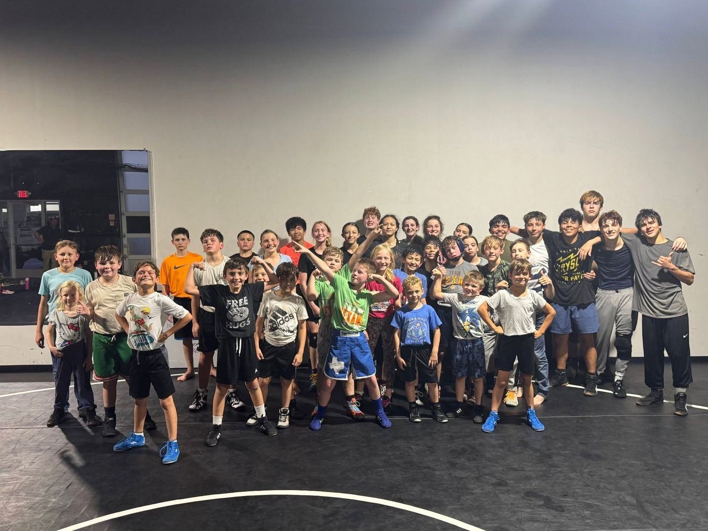 A full room of Texans Wrestling Club wrestlers on the mat in Argyle, Texas
