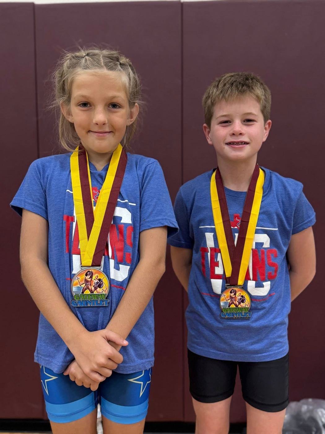 Two young Texans wrestlers wearing medals